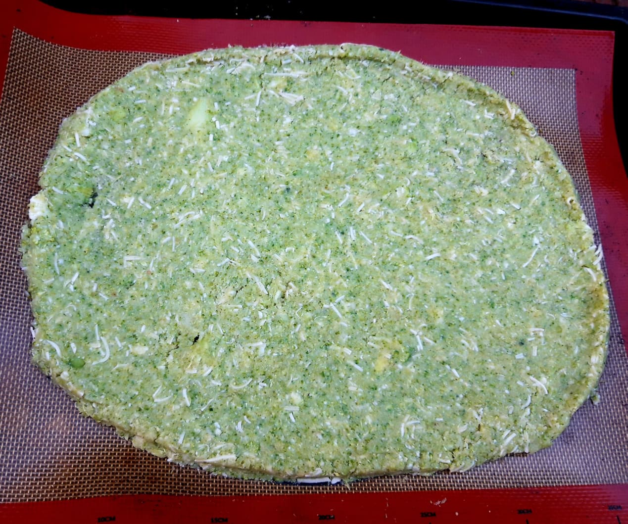 Cauliflower, broccoli, zucchini pizza base with pesto.